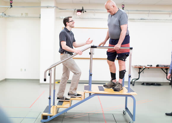 Physical therapy student helps a client during rehabilitation exercises