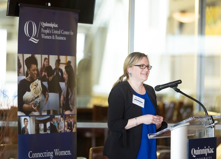 Julia Fullick speaking behind a podium